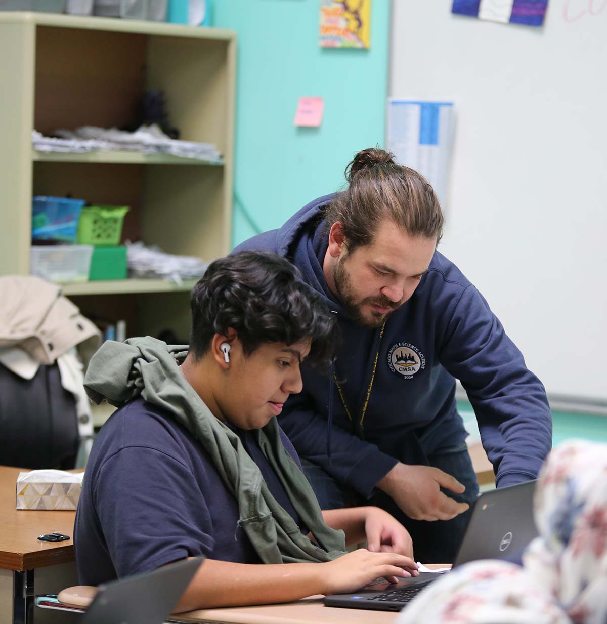 Student drawing in a classroom.