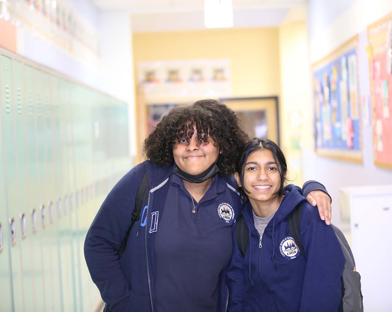 Teacher or school staff member warmly interacting with a student outside